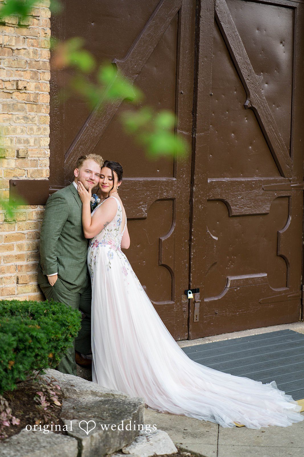 Griffin + Lauren Couple kissing by a wooden door