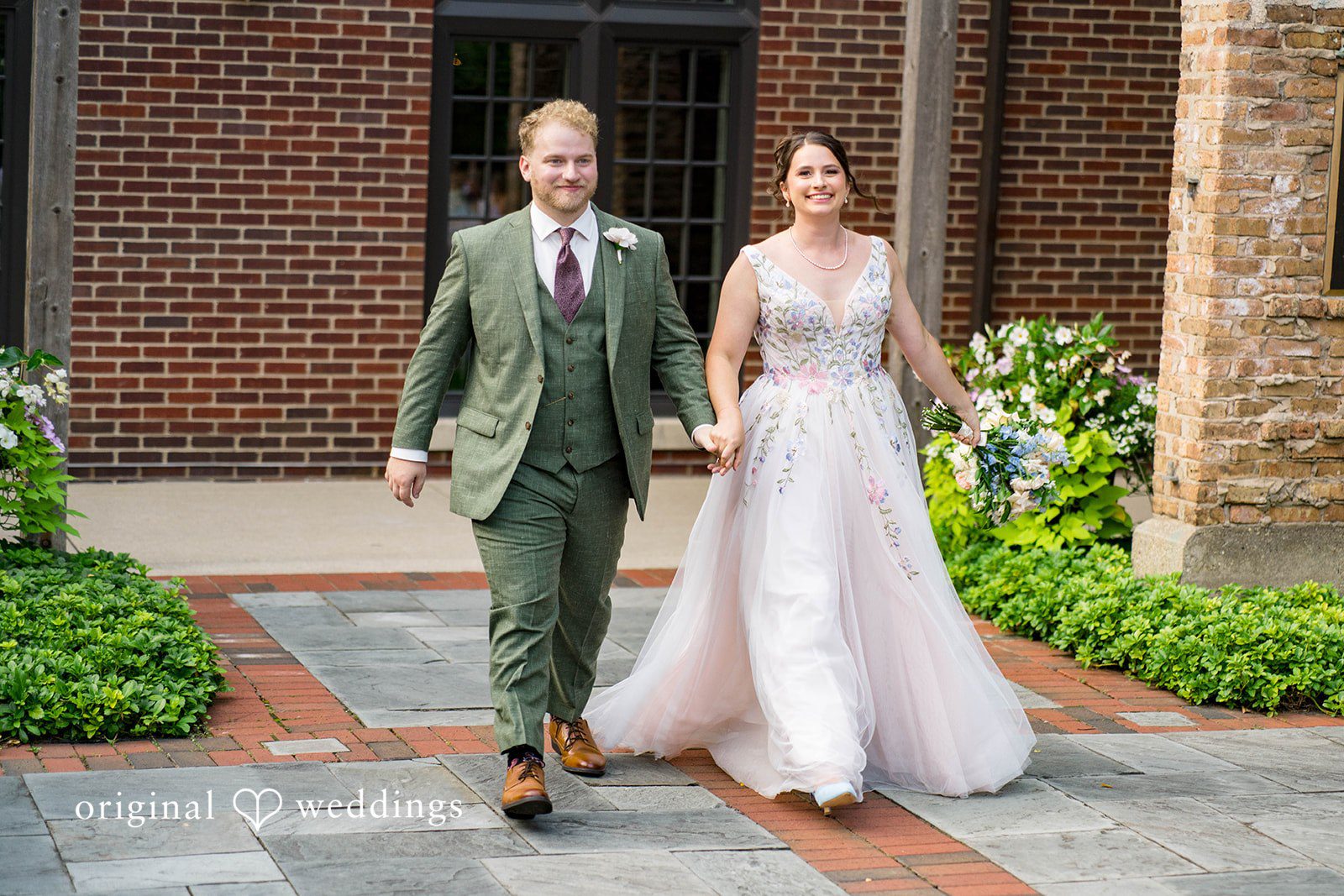 Griffin + Lauren Couple walking hand in hand through the garden, captured by Chicago wedding photographers from Original Weddings at Community House Winnetka