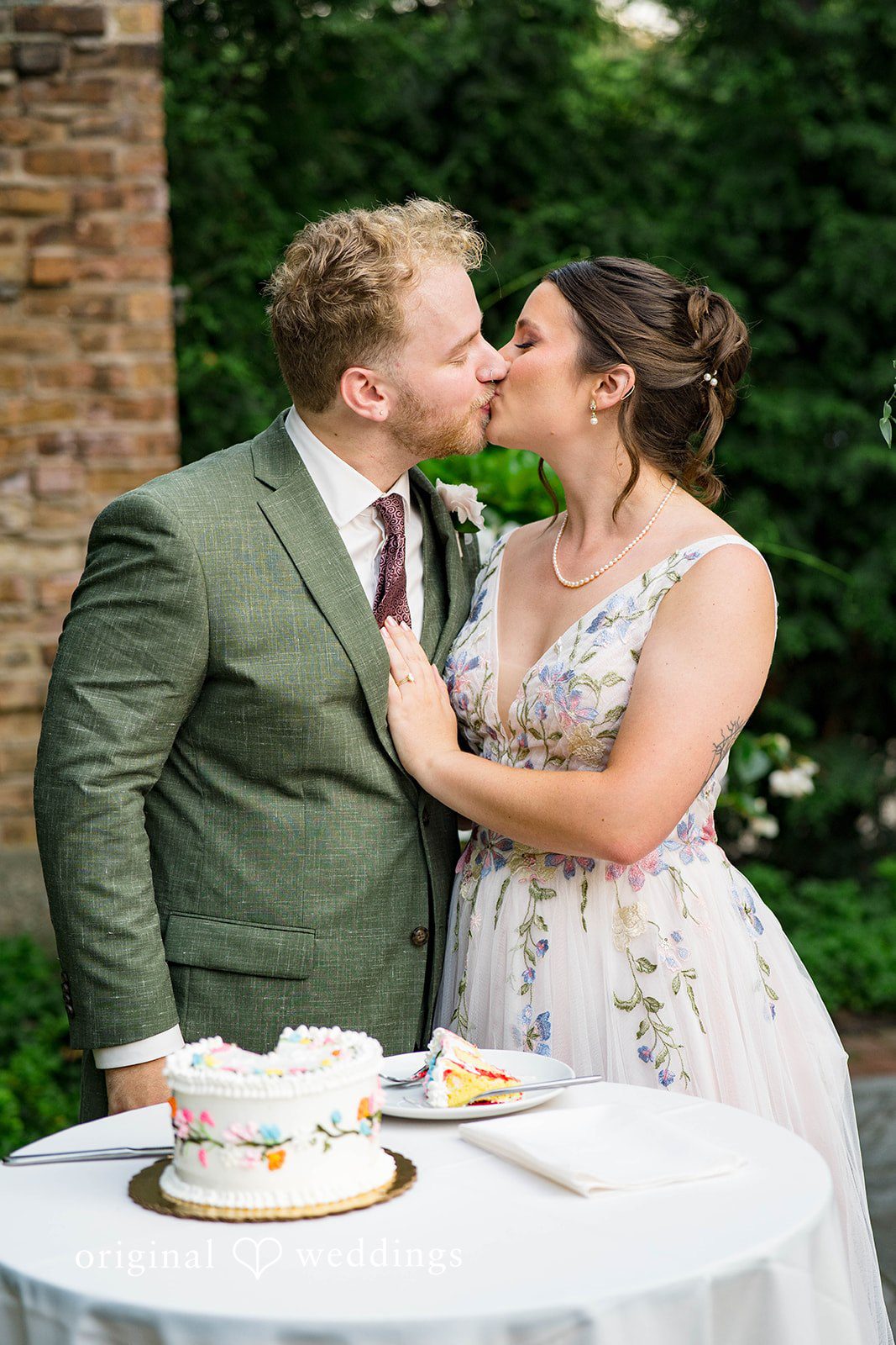 Griffin + Lauren Couple sharing a sweet moment at the cake table