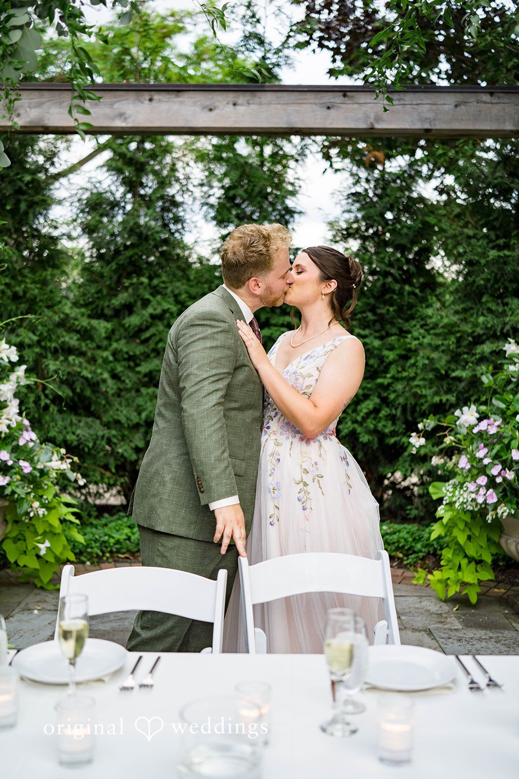 Griffin + Lauren Couple kissing near the reception tables