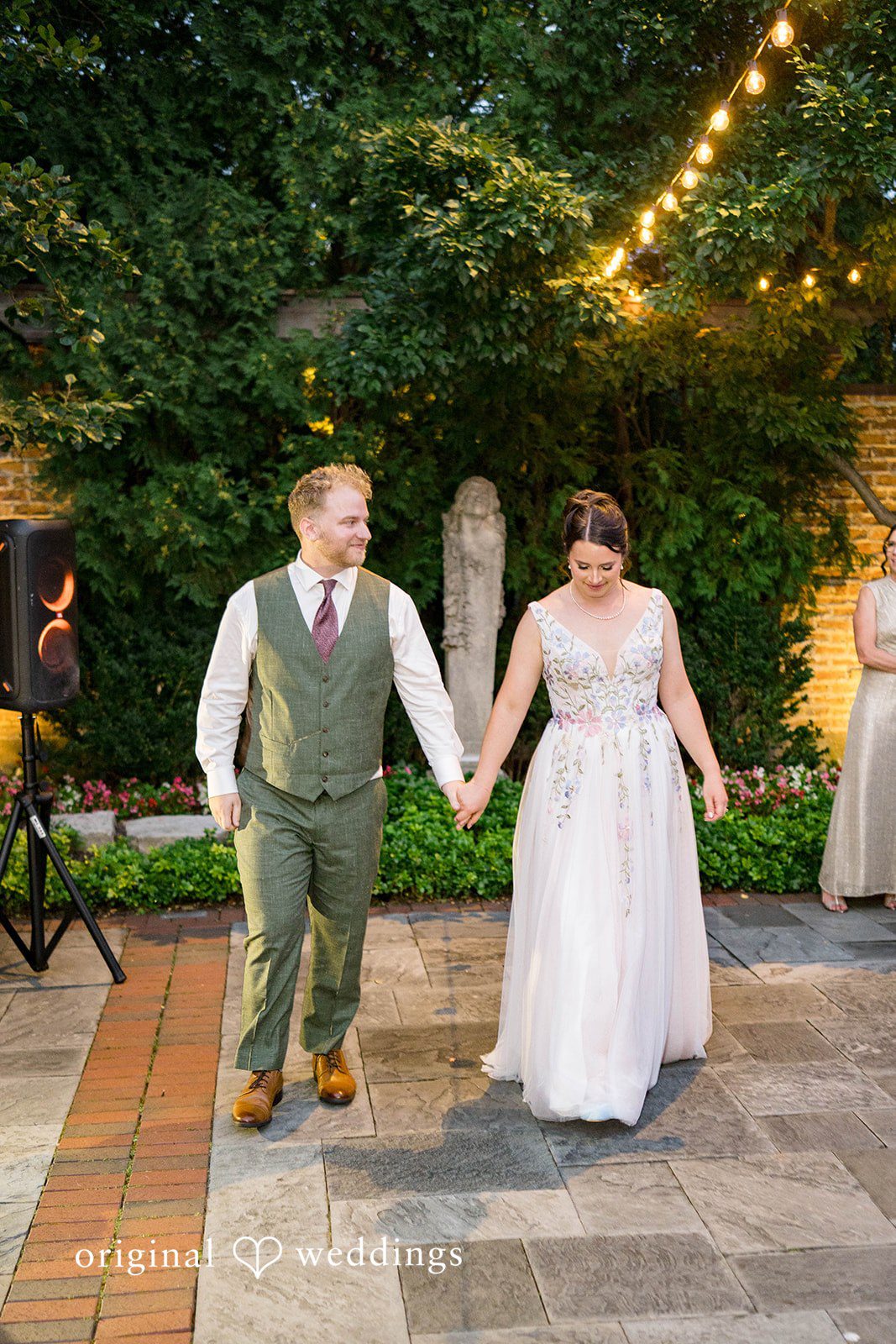 Griffin + Lauren Couple posing under string lights in the garden