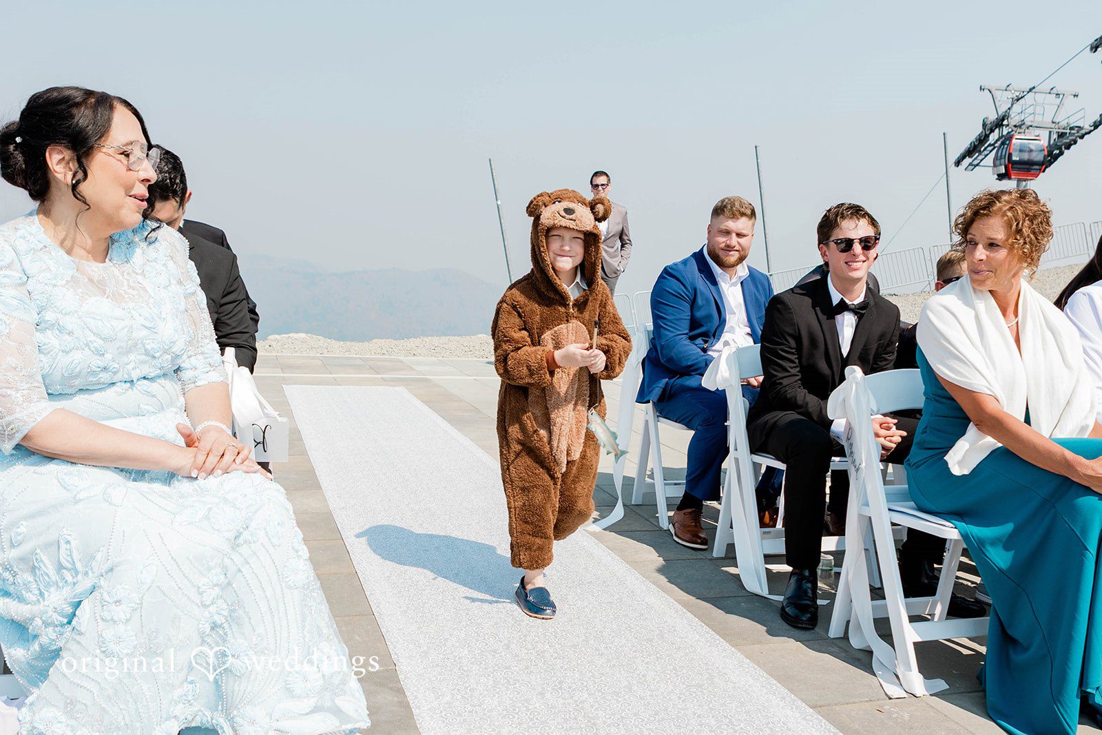 Bethany + Ryan Wedding guests walk up concrete stairs at an elevated venue.