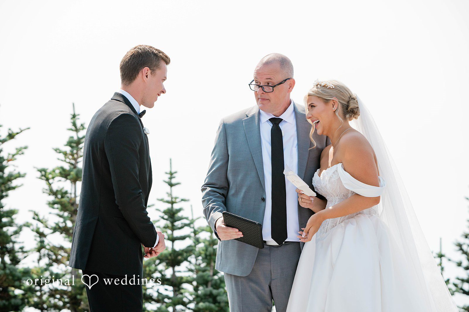 Bethany + Ryan A bride and groom exchange vows in front of a wedding officiant.