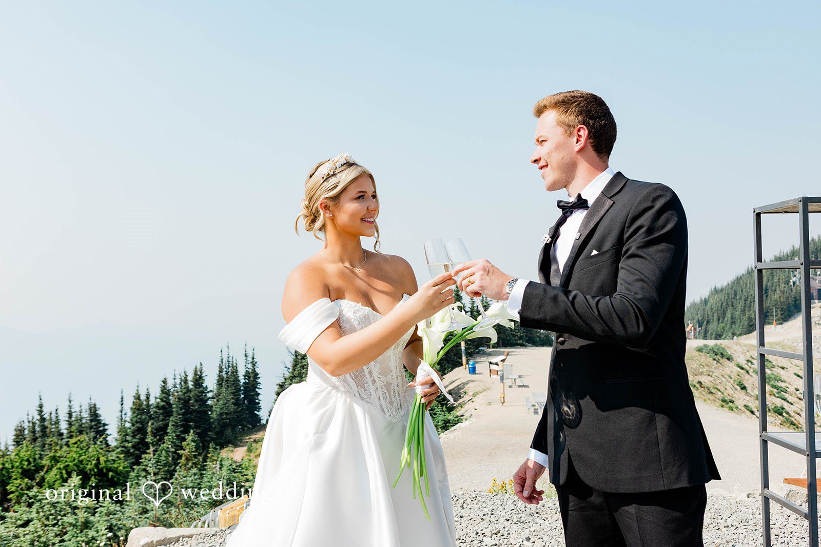 Bethany + Ryan A bride and groom stand together laughing during their outdoor wedding portrait session.
