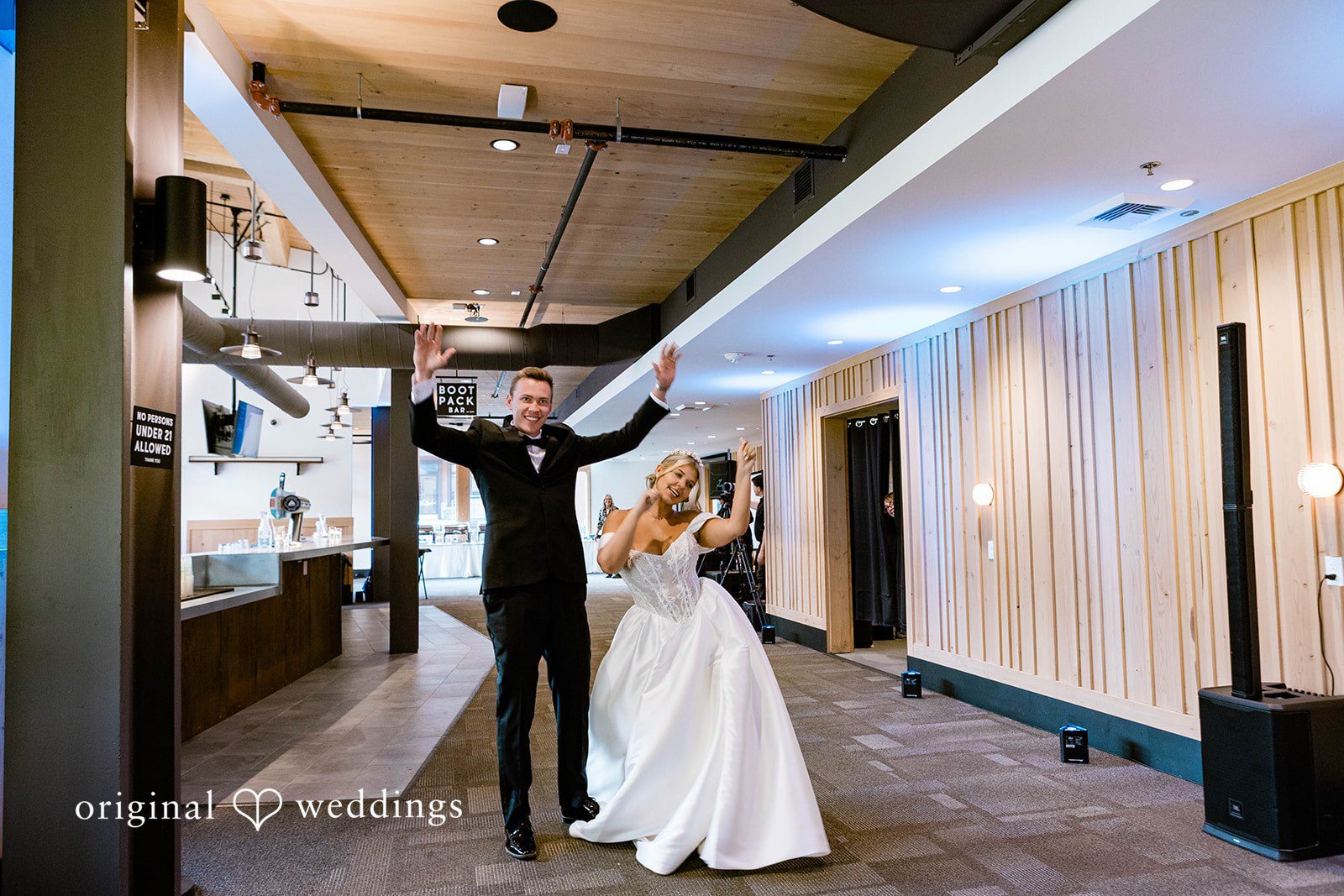 Bethany + Ryan A bride and groom make their grand entrance into a modern reception hall.
