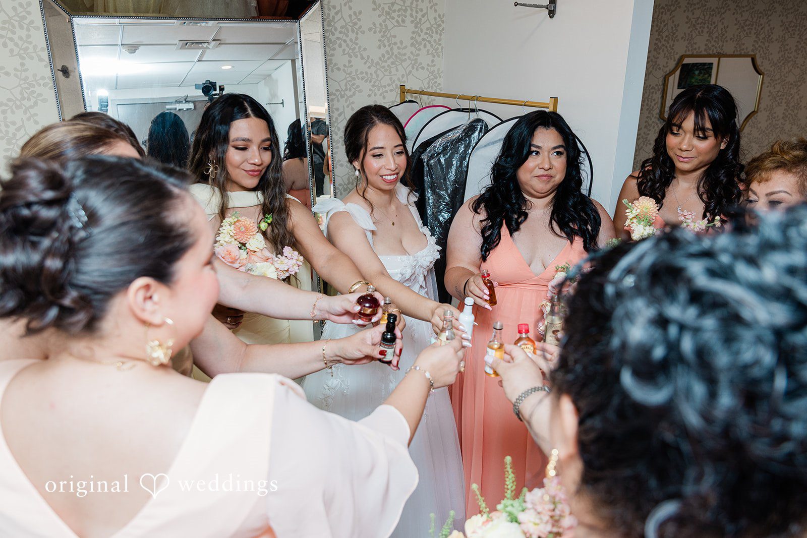 Bride laughing with friends while getting ready