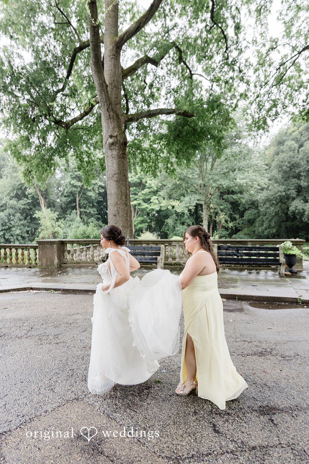 Bride lifting her gown on a garden path