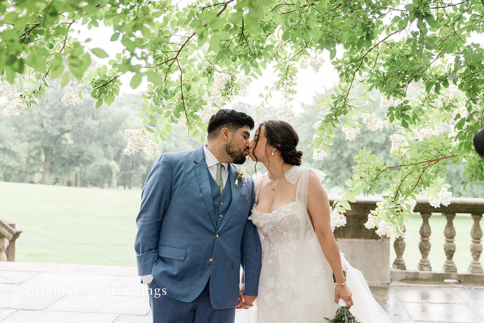 Couple sharing a kiss on the terrace at Curtis Arboretum