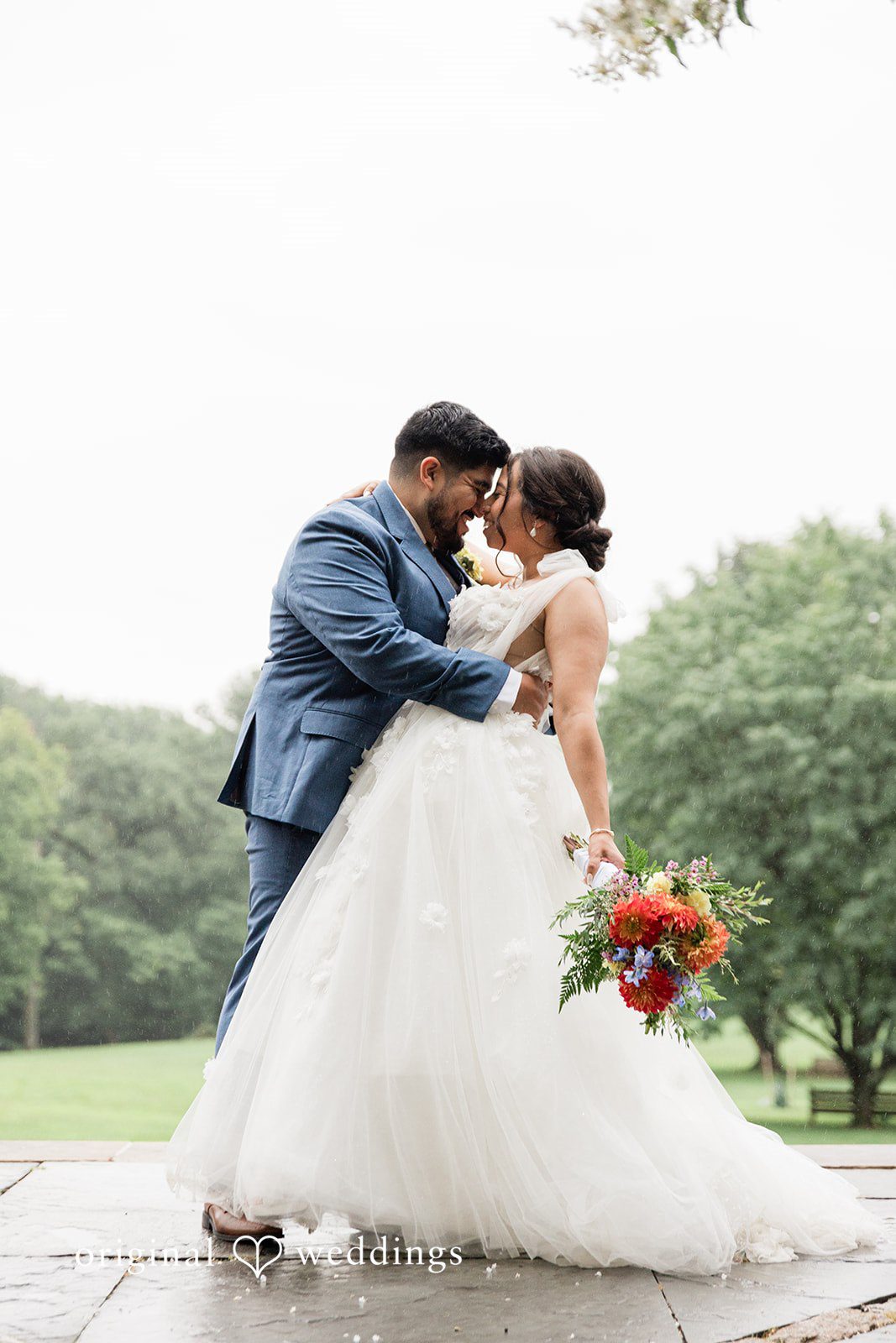 Couple kissing in the gardens at Curtis Arboretum