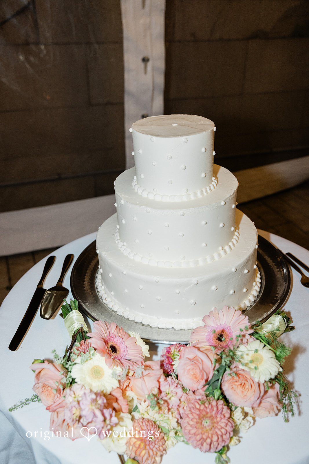 White wedding cake with blush flowers