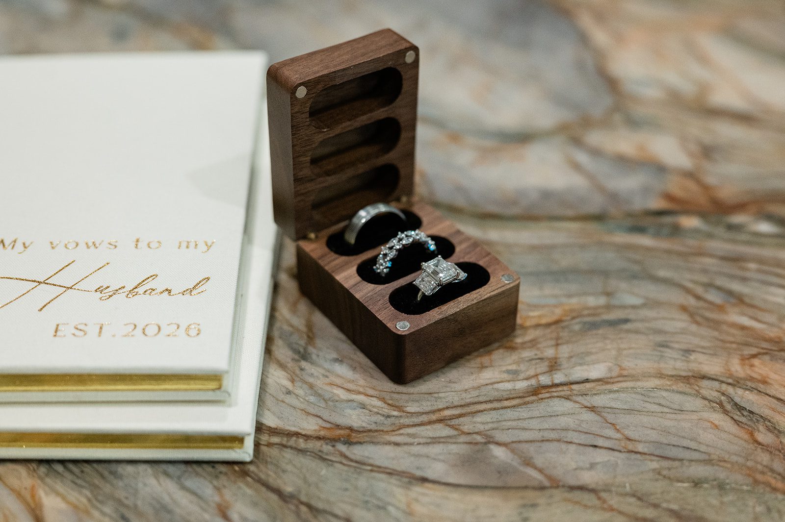 Wedding vow books and wooden ring box with wedding rings