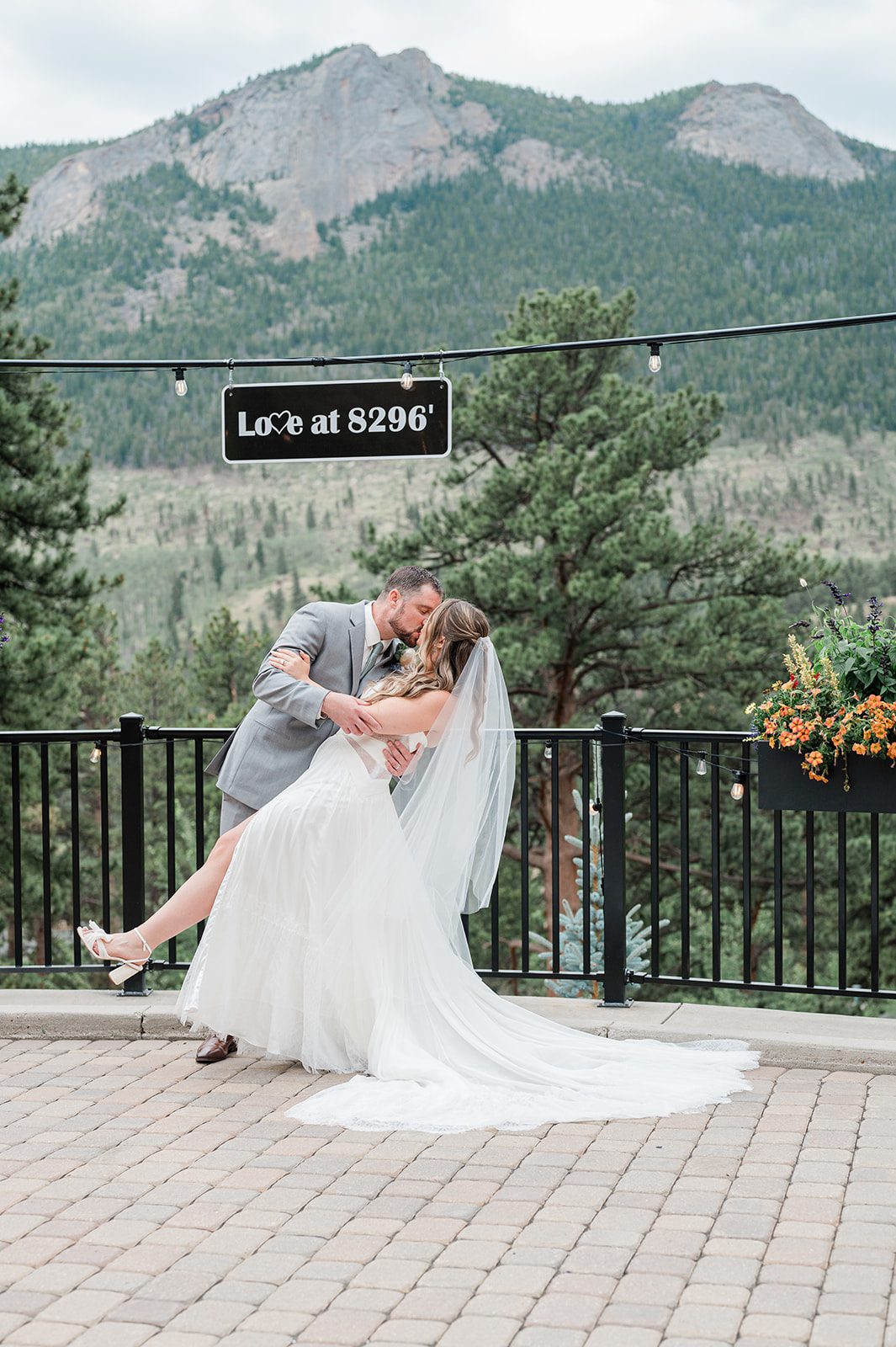 Bride posing by the railing with mountain views at Della Terra Mountain Chateau