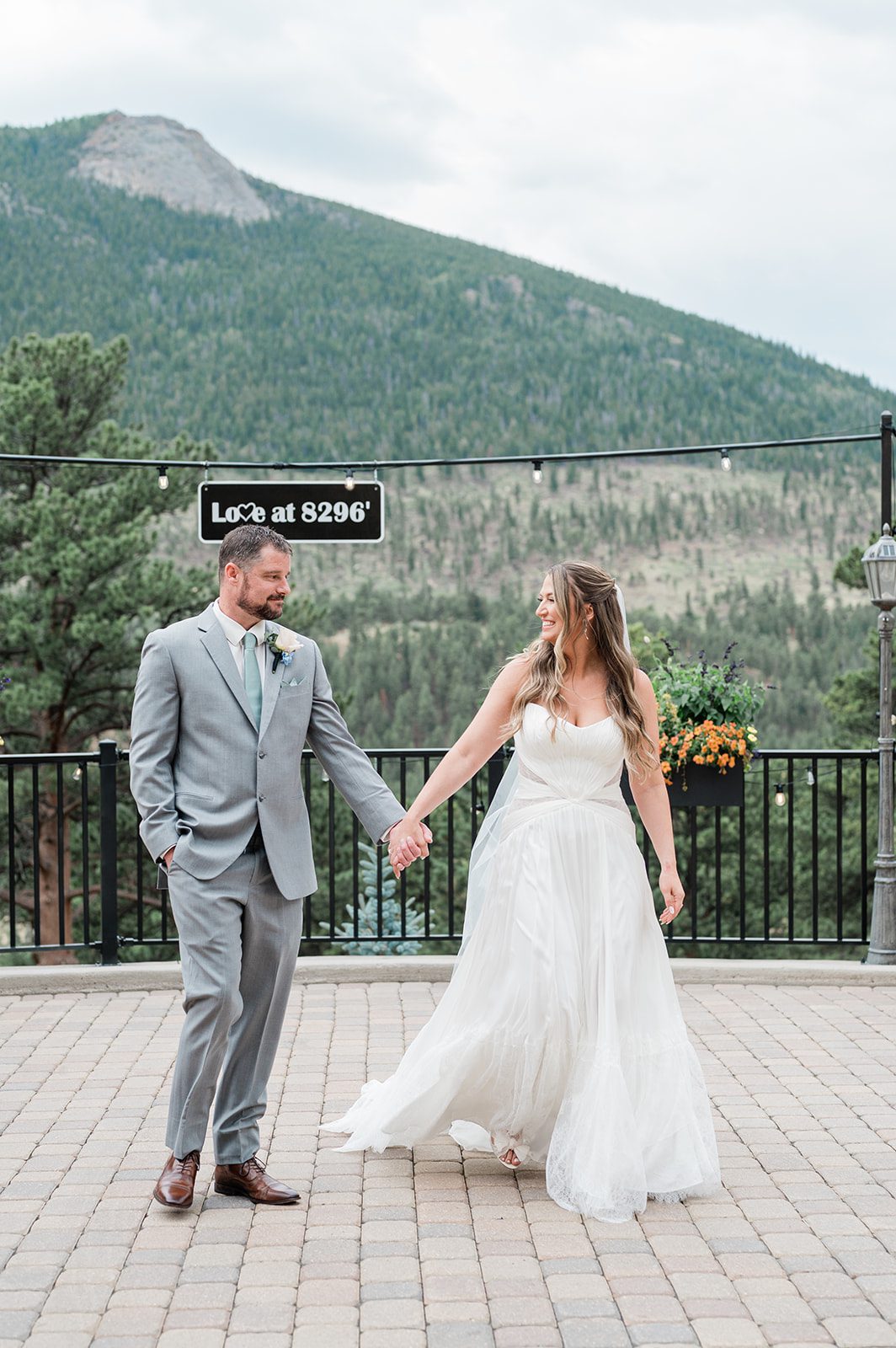 Couple holding hands on the overlook patio at Della Terra Mountain Chateau