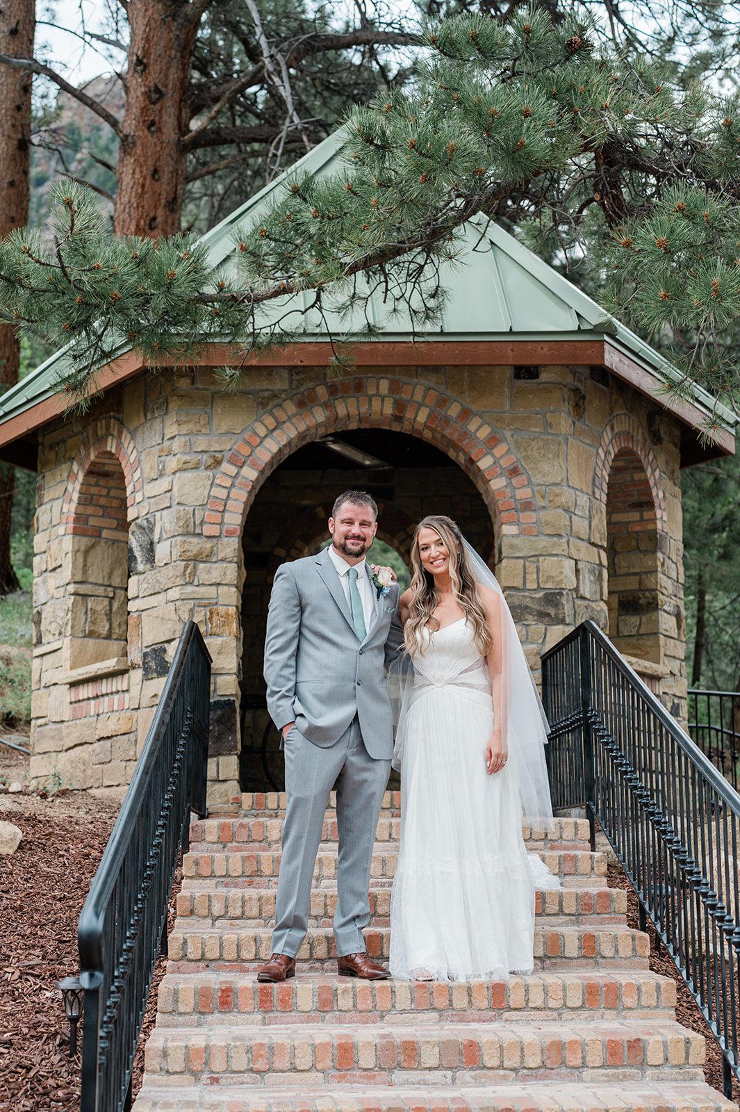 Couple posing on the stone gazebo steps at Della Terra Mountain Chateau
