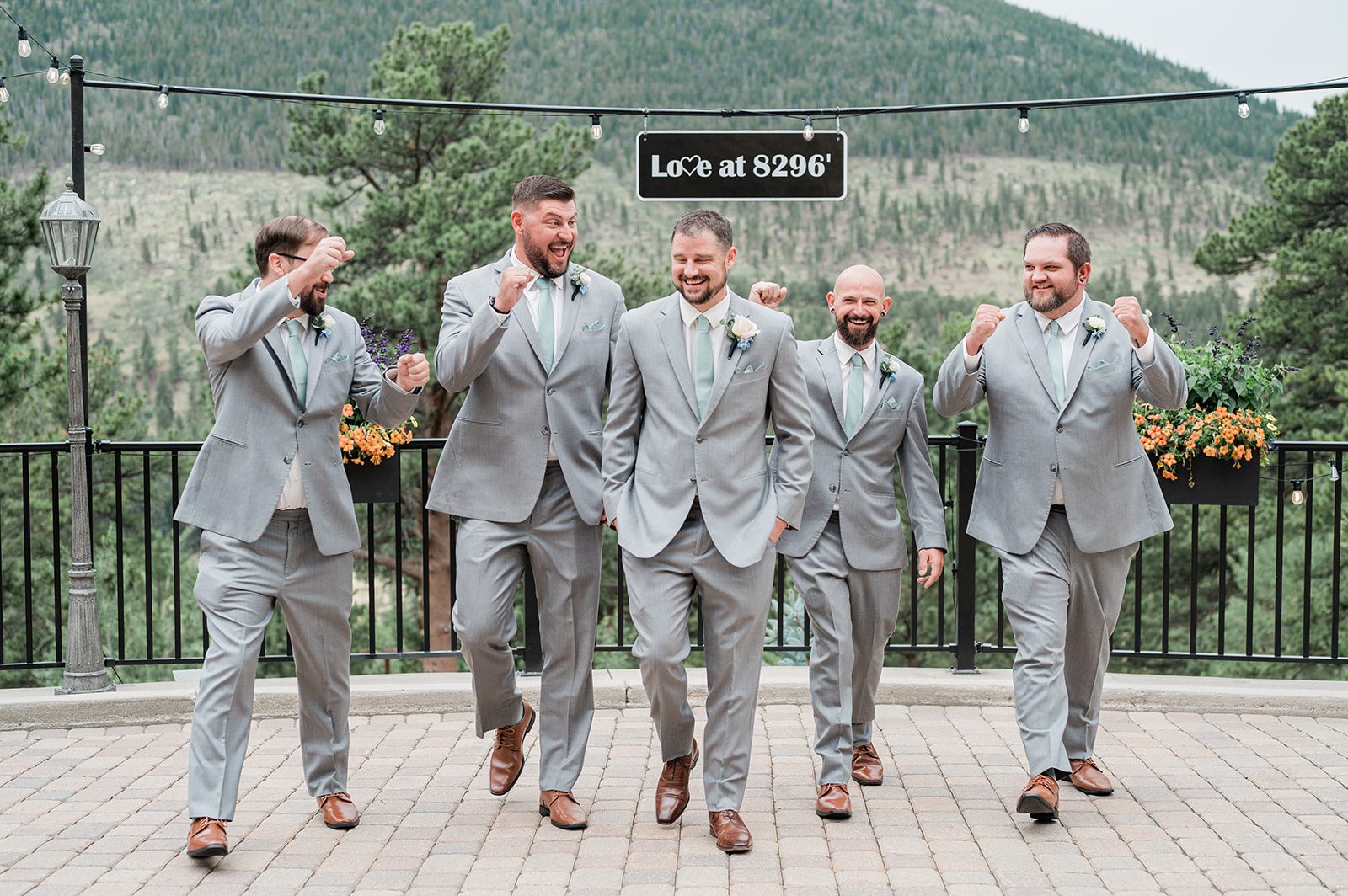 Groom and groomsmen in gray suits with mountain views at Della Terra Mountain Chateau