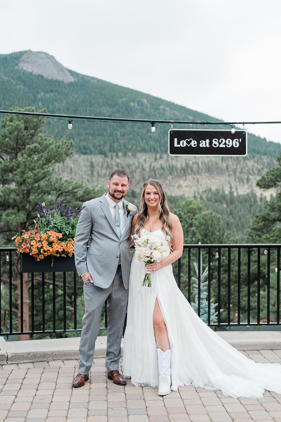 Bride and groom by the Love at 8296 sign at Della Terra Mountain Chateau