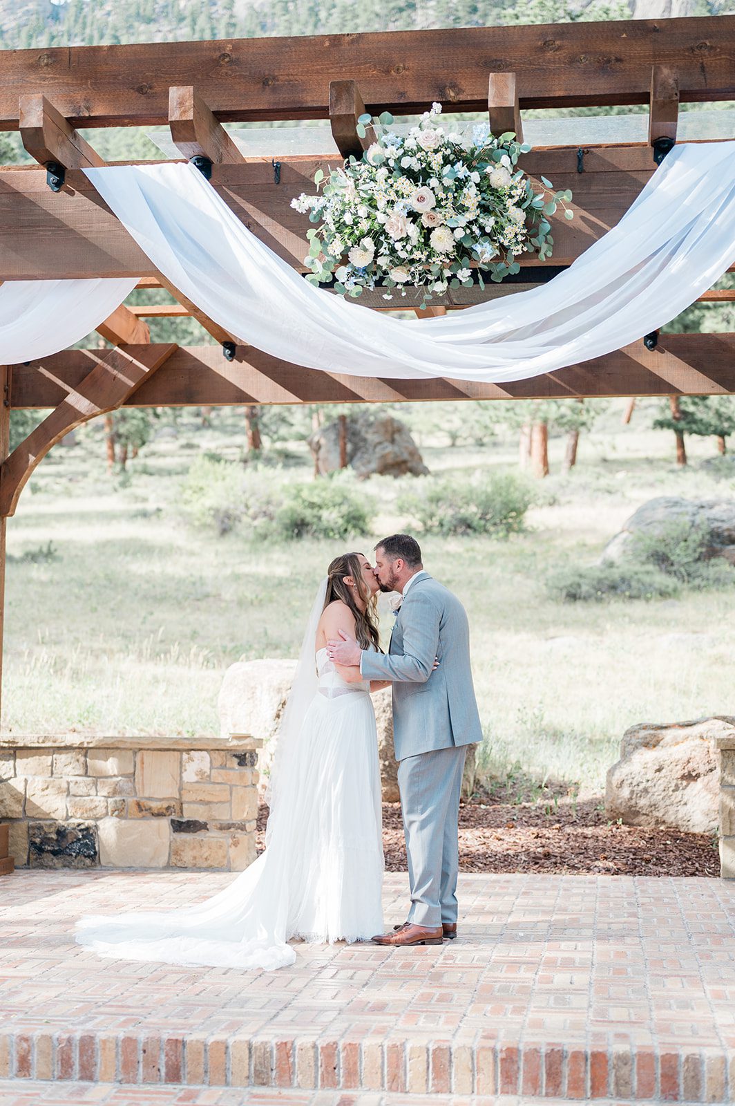 First kiss as a married couple at the ceremony arbor