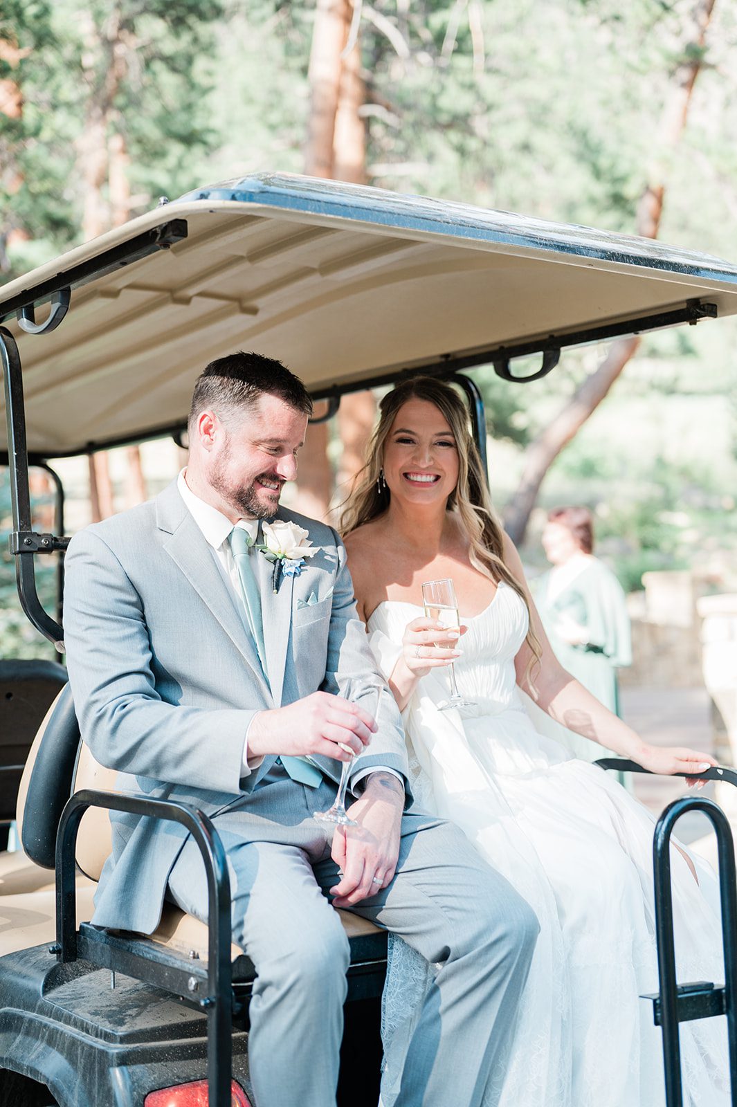 Newlyweds laughing together in a golf cart