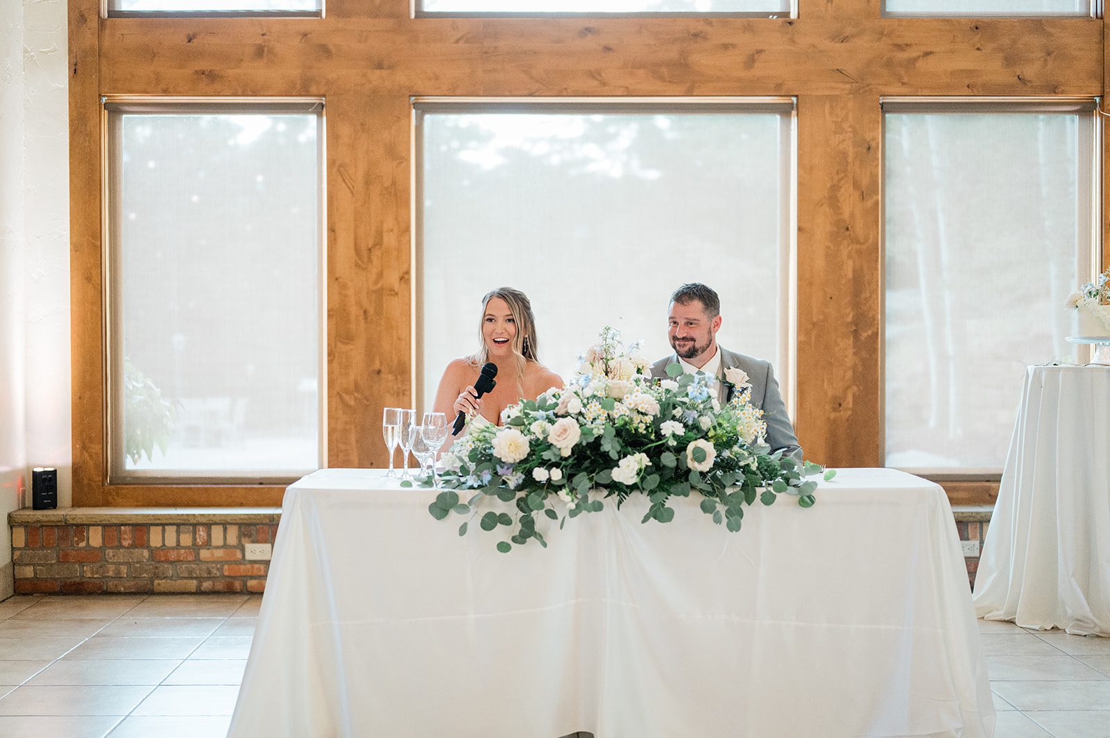 Newlyweds at their sweetheart table during the reception