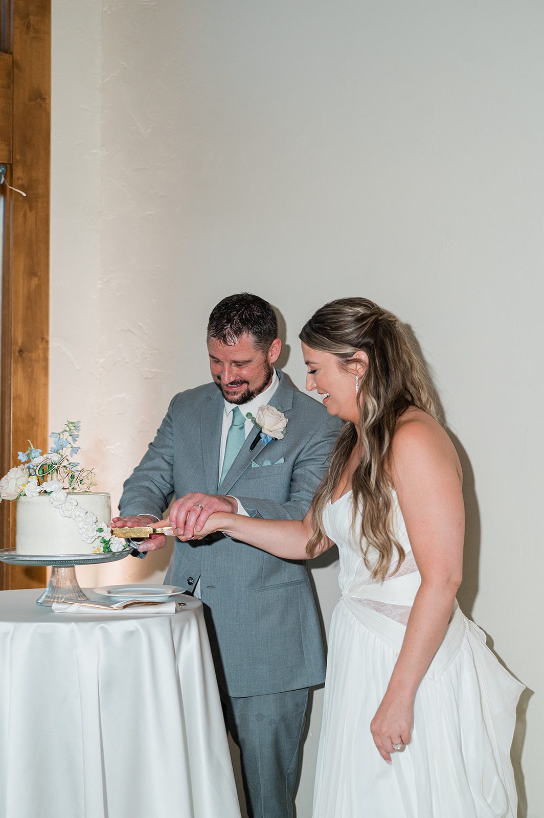 Bride and groom cutting their wedding cake
