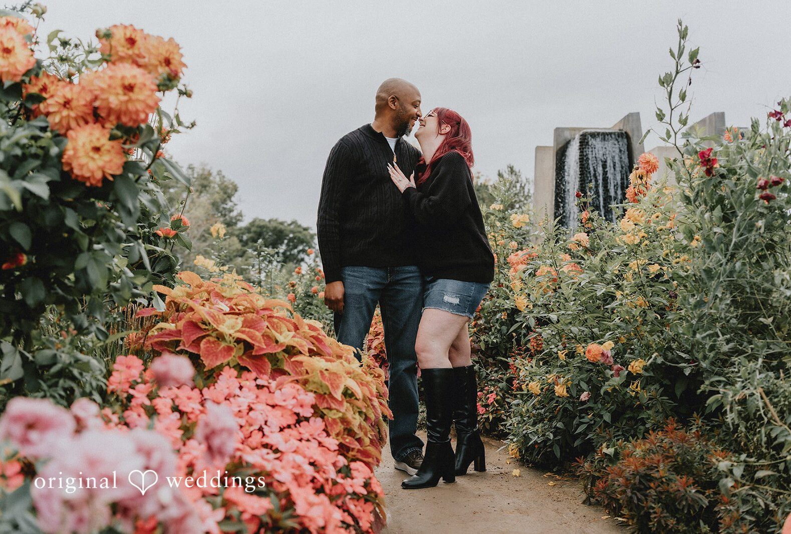 Nikki and Kevin surrounded by orange and pink blooms, captured by Engagement Photography Services from Original Weddings at Denver Botanic Gardens