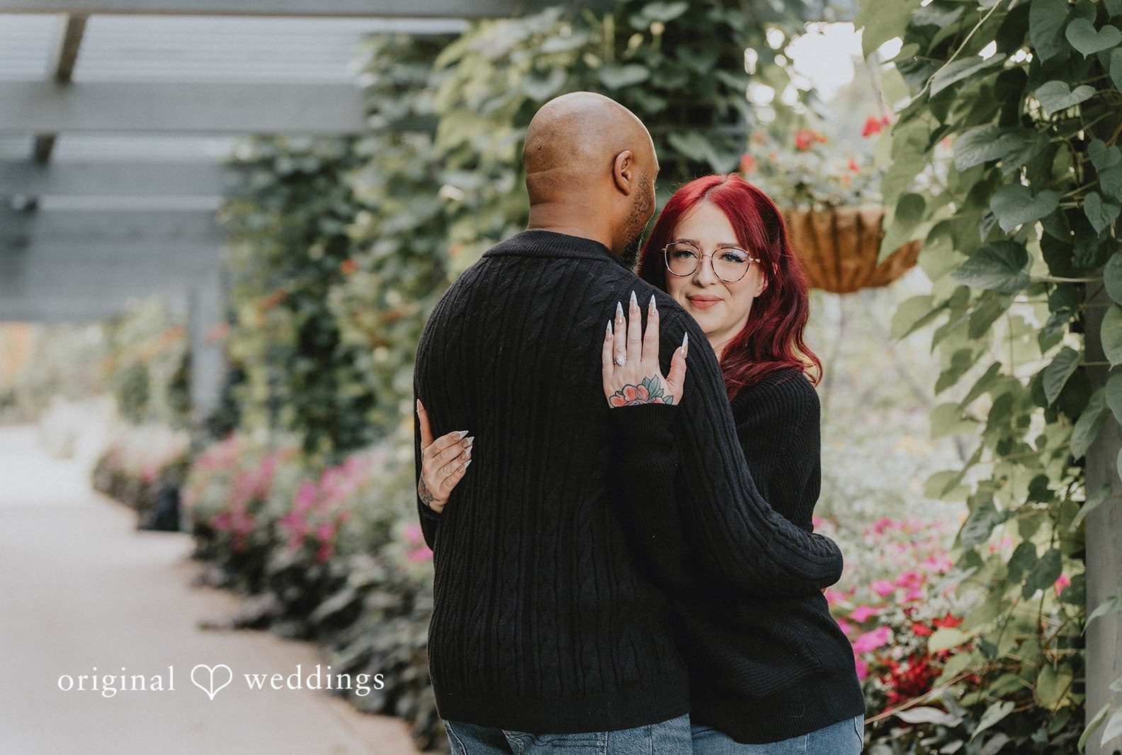 Couple embracing among the garden flowers, captured by Engagement Photography Services from Original Weddings at Denver Botanic Gardens