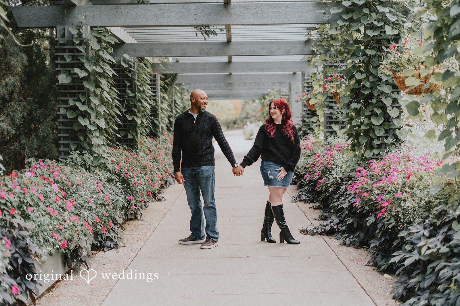 Nikki + Kevin Nikki and Kevin walking hand in hand down the pergola walkway