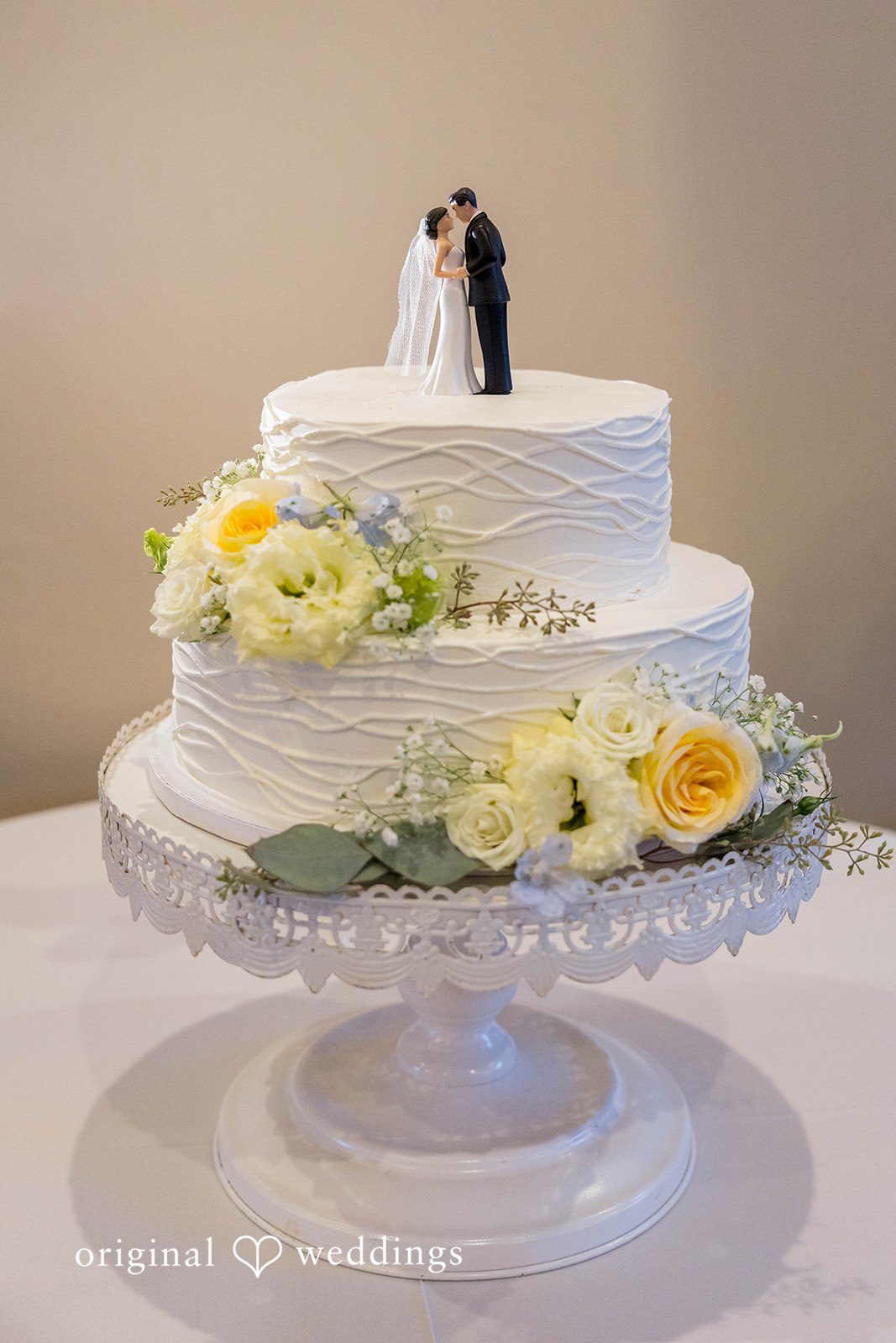 Yummy wedding cake adorned with fresh blooms
