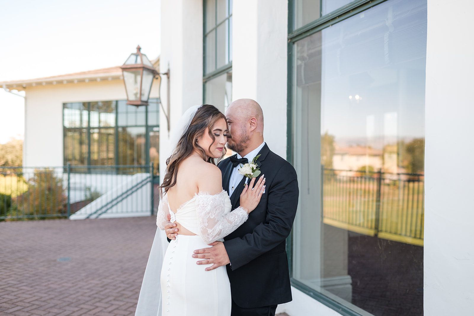 eagle-ridge-timeless-san-francisco-jesse-victoria-jesse-victoria-028-34 Bride and groom embracing by the clubhouse windows, captured by San Francisco wedding photographers from Original Weddings at Eagle Ridge