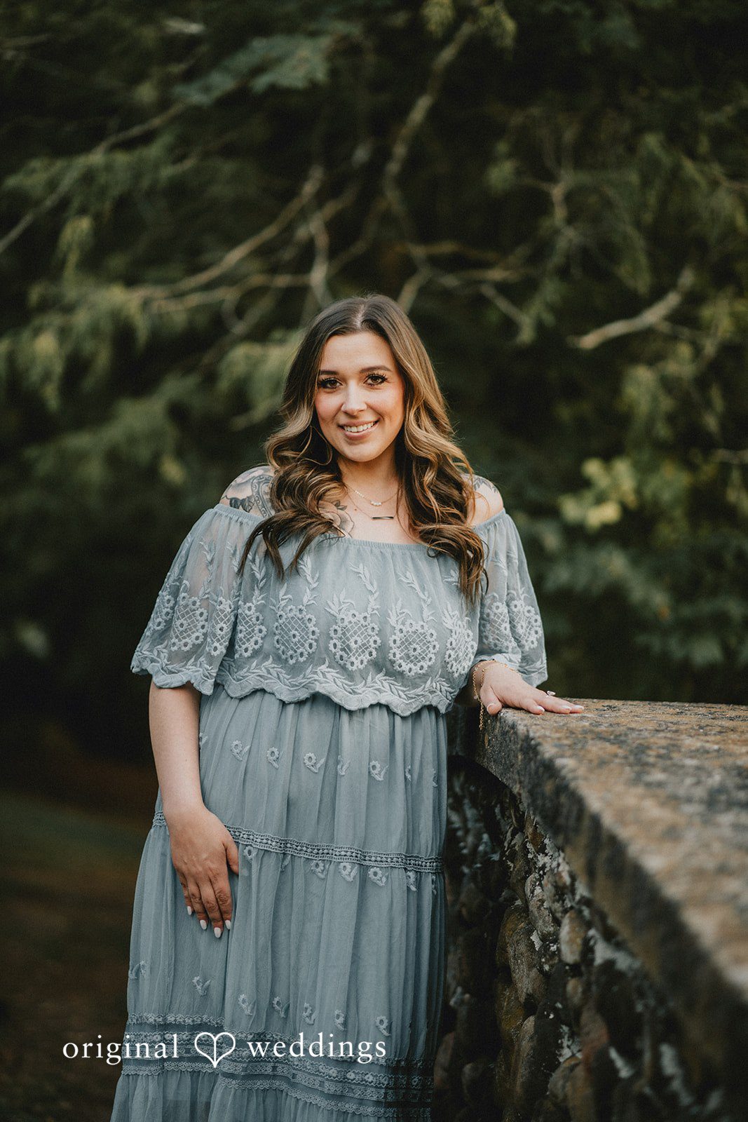 September 24, 2026 – Kaitlynn & Samuel – (ID-5685) Kaitlynn in a blue dress by the stone wall at Elizabeth Park