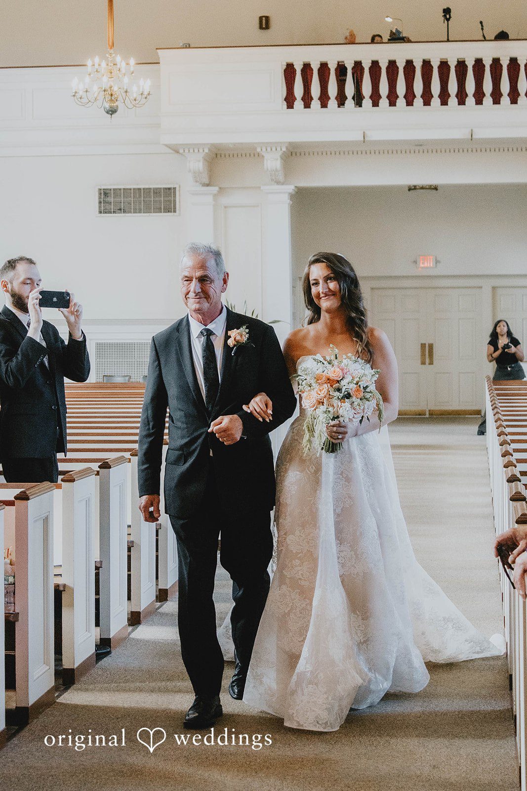Alexa + Frank Newlyweds walking back up the aisle as guests cheer