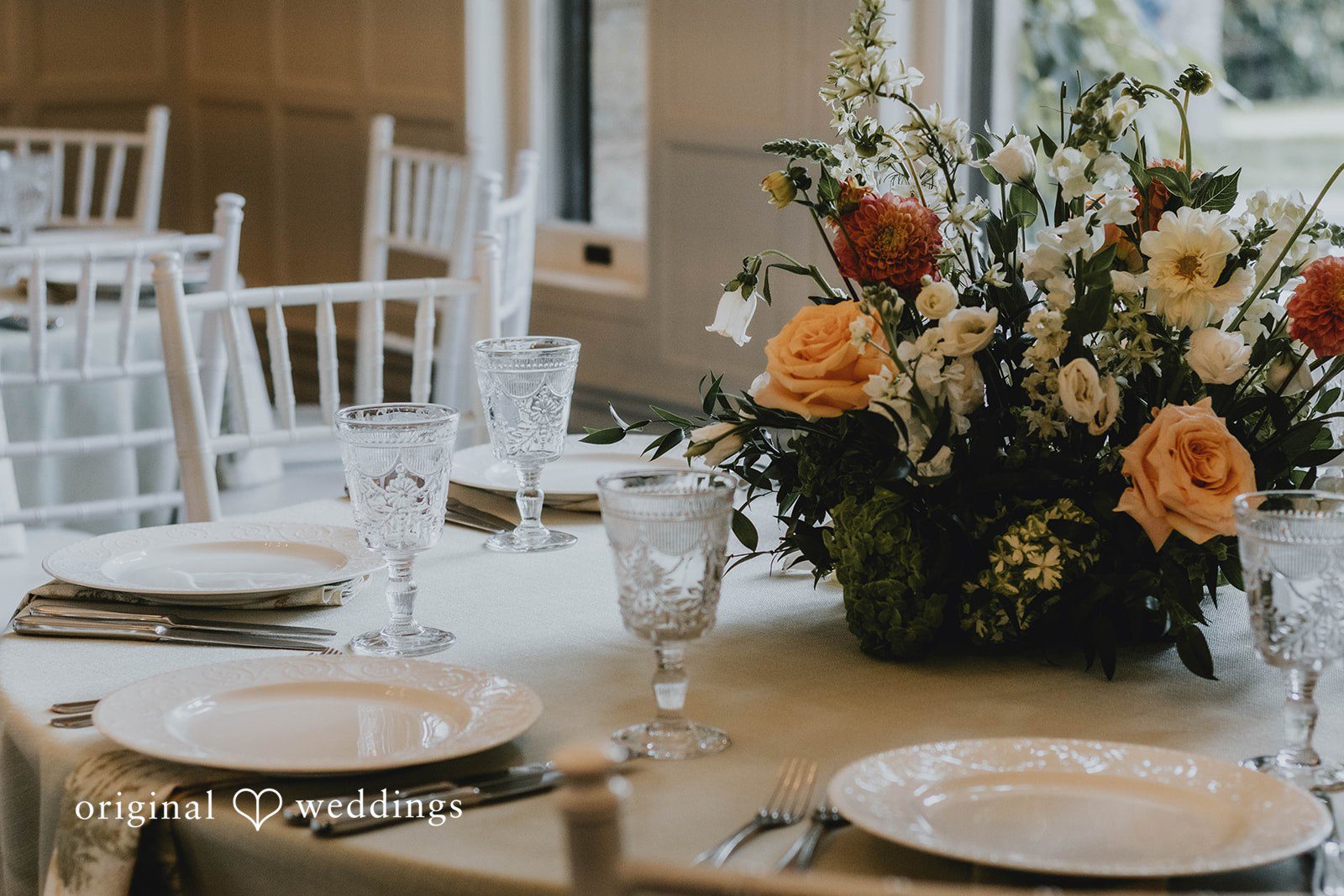 Alexa + Frank Reception table with peach and white flowers at Eolia Mansion