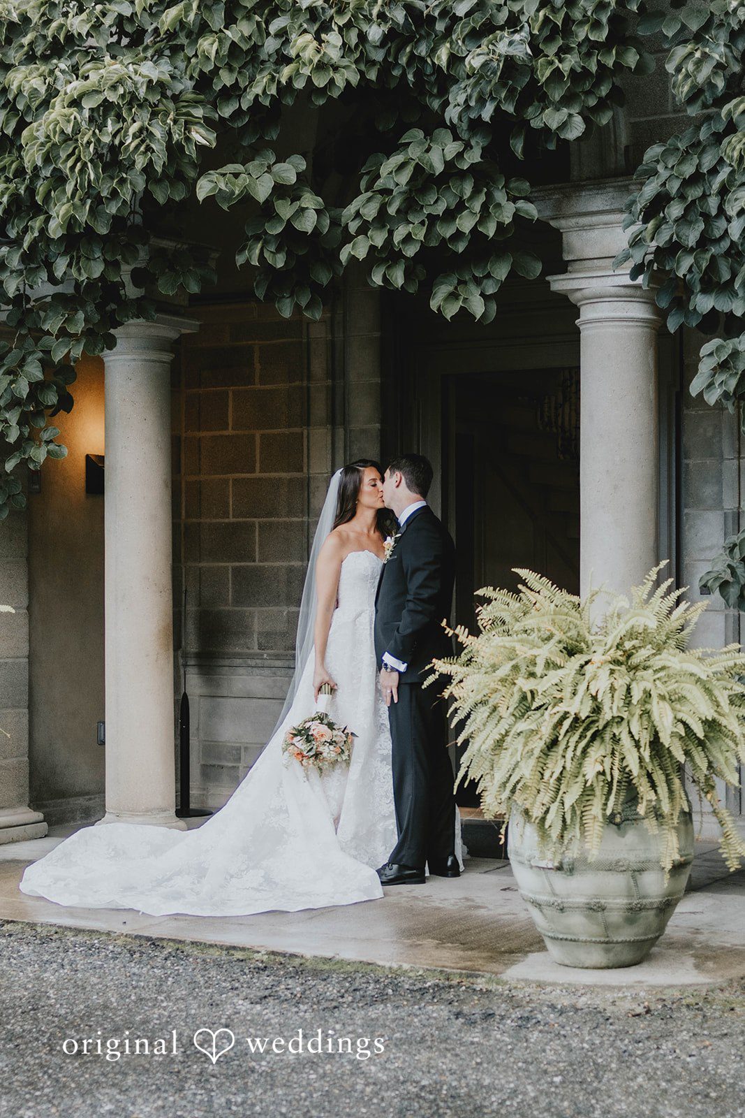 Alexa + Frank Bride and groom in a garden archway at Eolia Mansion