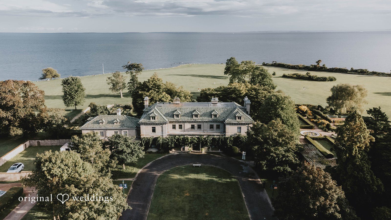 Alexa + Frank Aerial view of Eolia Mansion and its grounds along the water