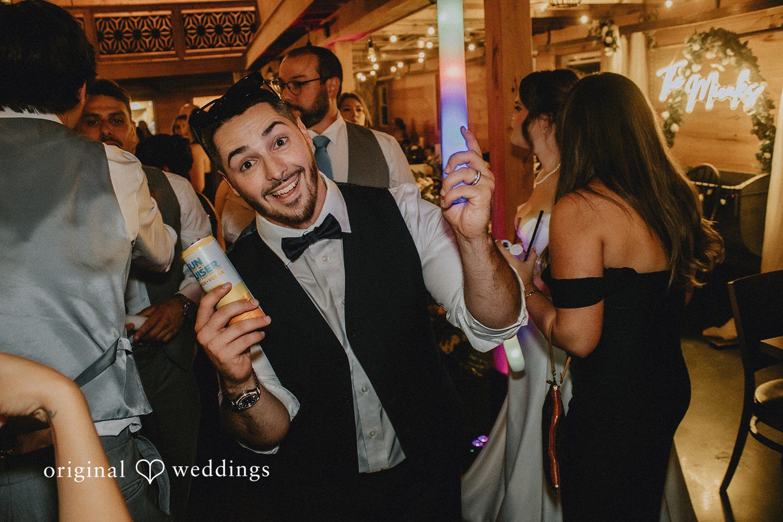 Sarah + Christopher Wedding guests smiling and dancing together at a reception.