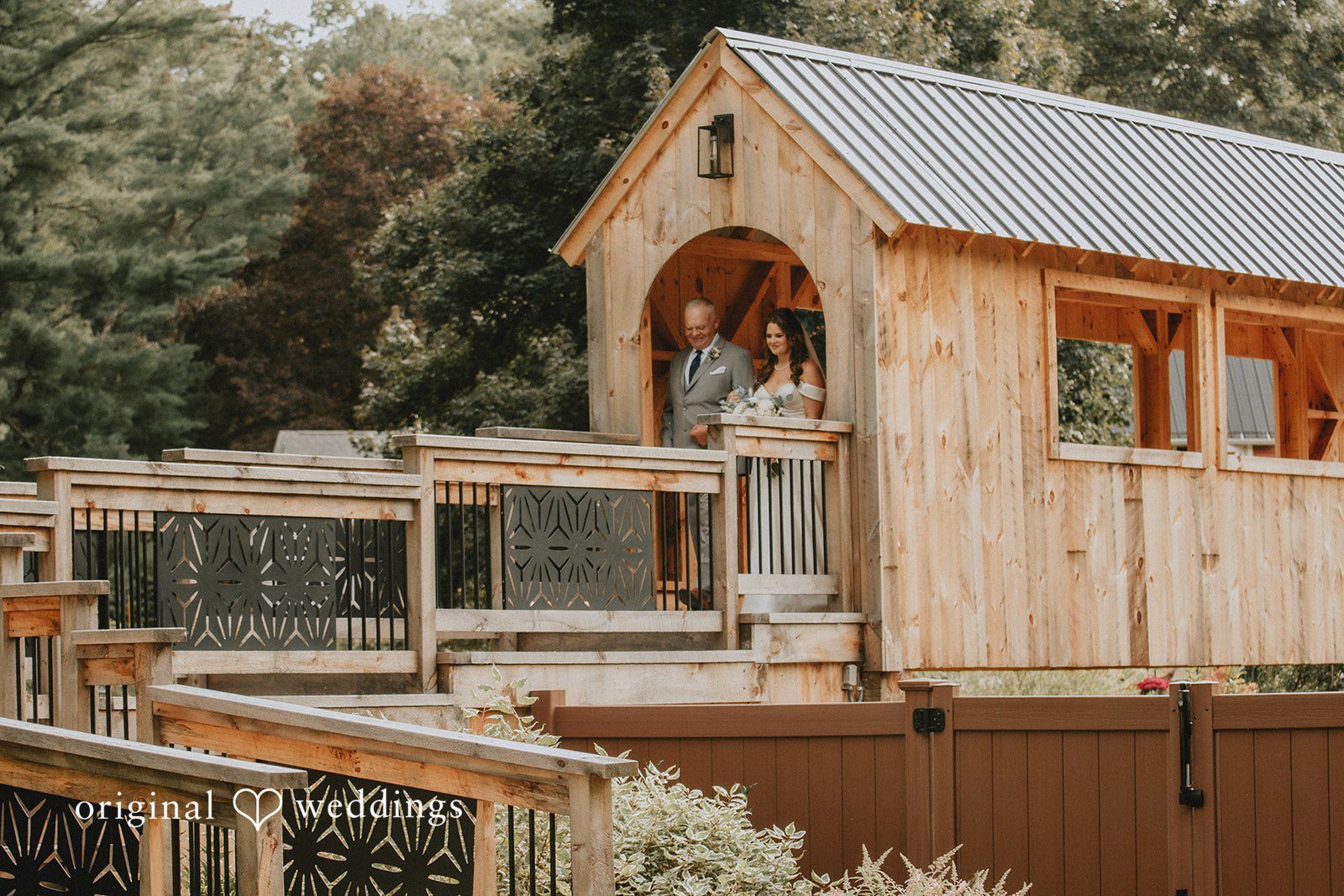 Sarah + Christopher A multi-tiered wooden cabin structure with an open porch.