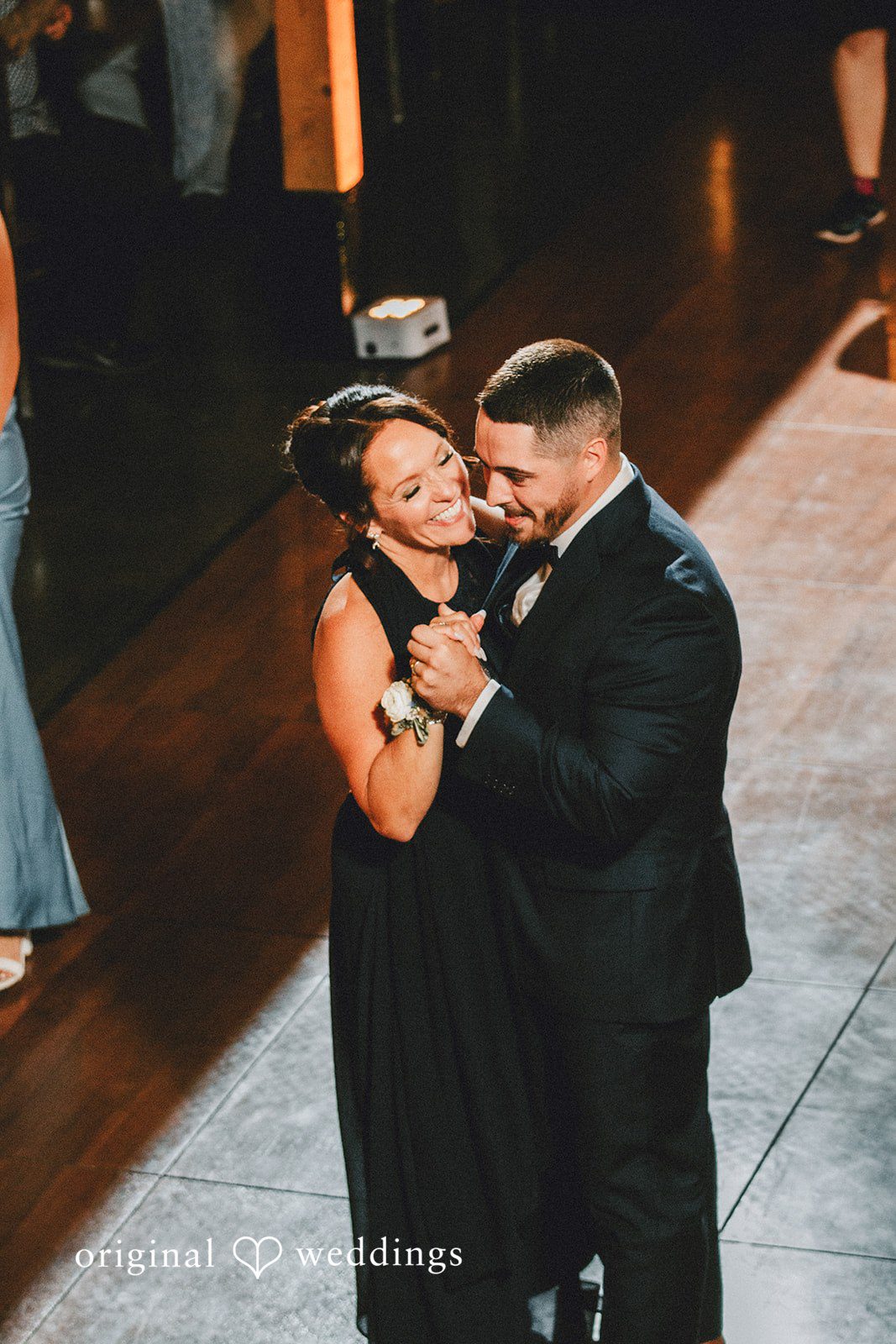 September 19, 2026 – Sarah & Christopher – (ID-4569) A women and groom sharing a dance under soft lighting.