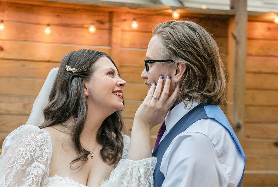 Leisa and TC sharing a sweet moment on the patio, captured by Indianapolis wedding photographers from Original Weddings at FAR Center for Contemporary Arts