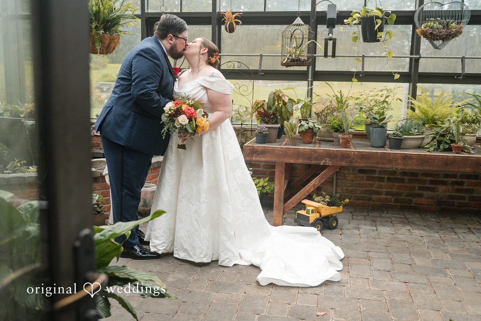 Andrew and Marian kissing in the greenhouse