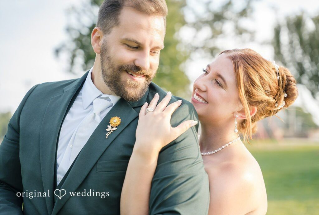 Alexis and Alex smiling together outdoors, captured by Milwaukee wedding photographers from Original Weddings at Fireman's Park Pavilion