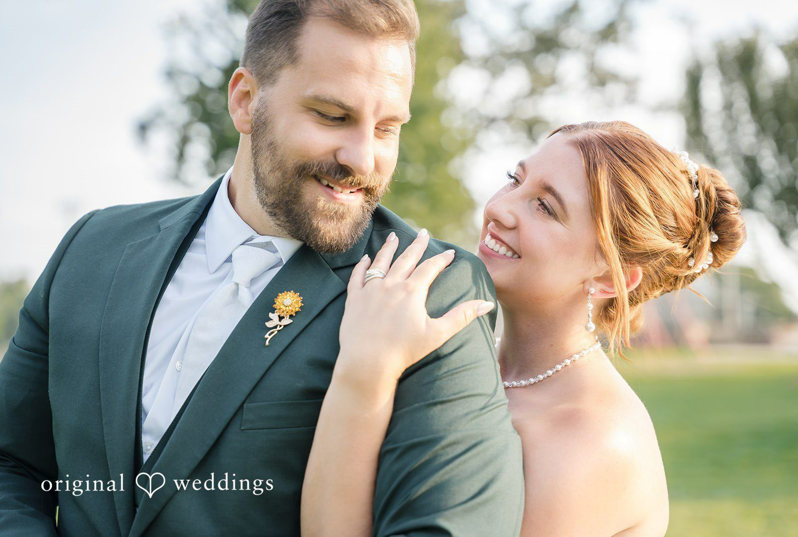 Alexis and Alex smiling together outdoors, captured by Milwaukee wedding photographers from Original Weddings at Fireman's Park Pavilion
