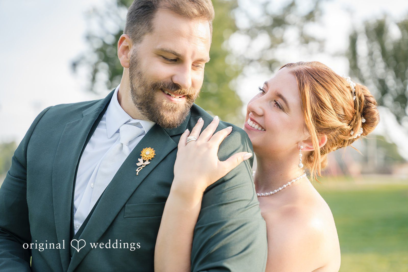 Alexis + Alex Alexis and Alex smiling together outdoors, captured by Milwaukee wedding photographers from Original Weddings at Fireman's Park Pavilion