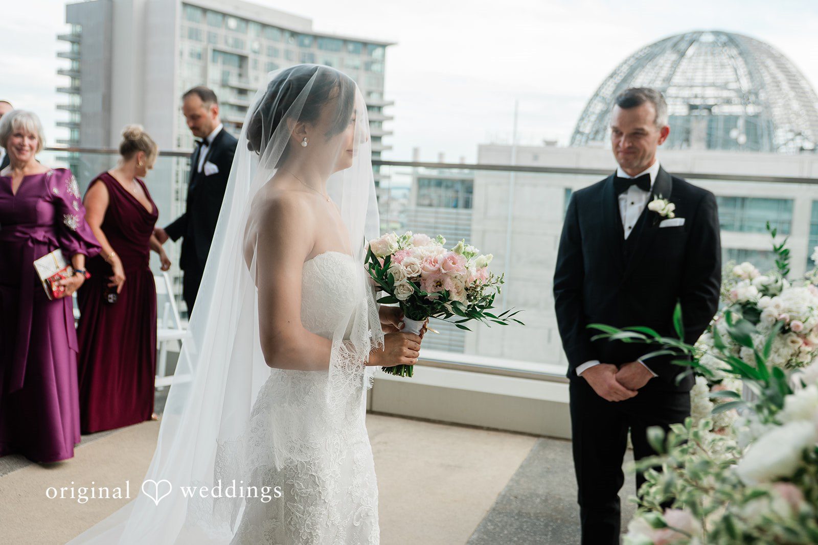 Groom watching the bride walk toward him