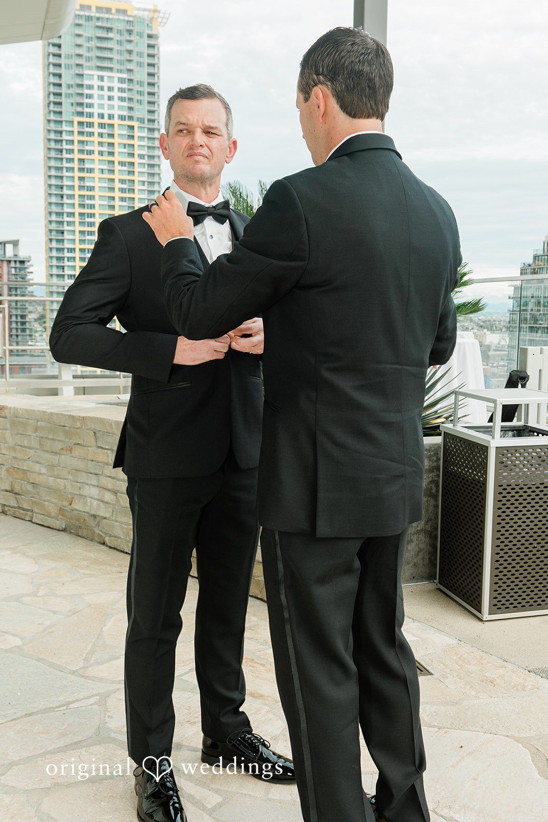 Groom getting ready with help from a groomsman