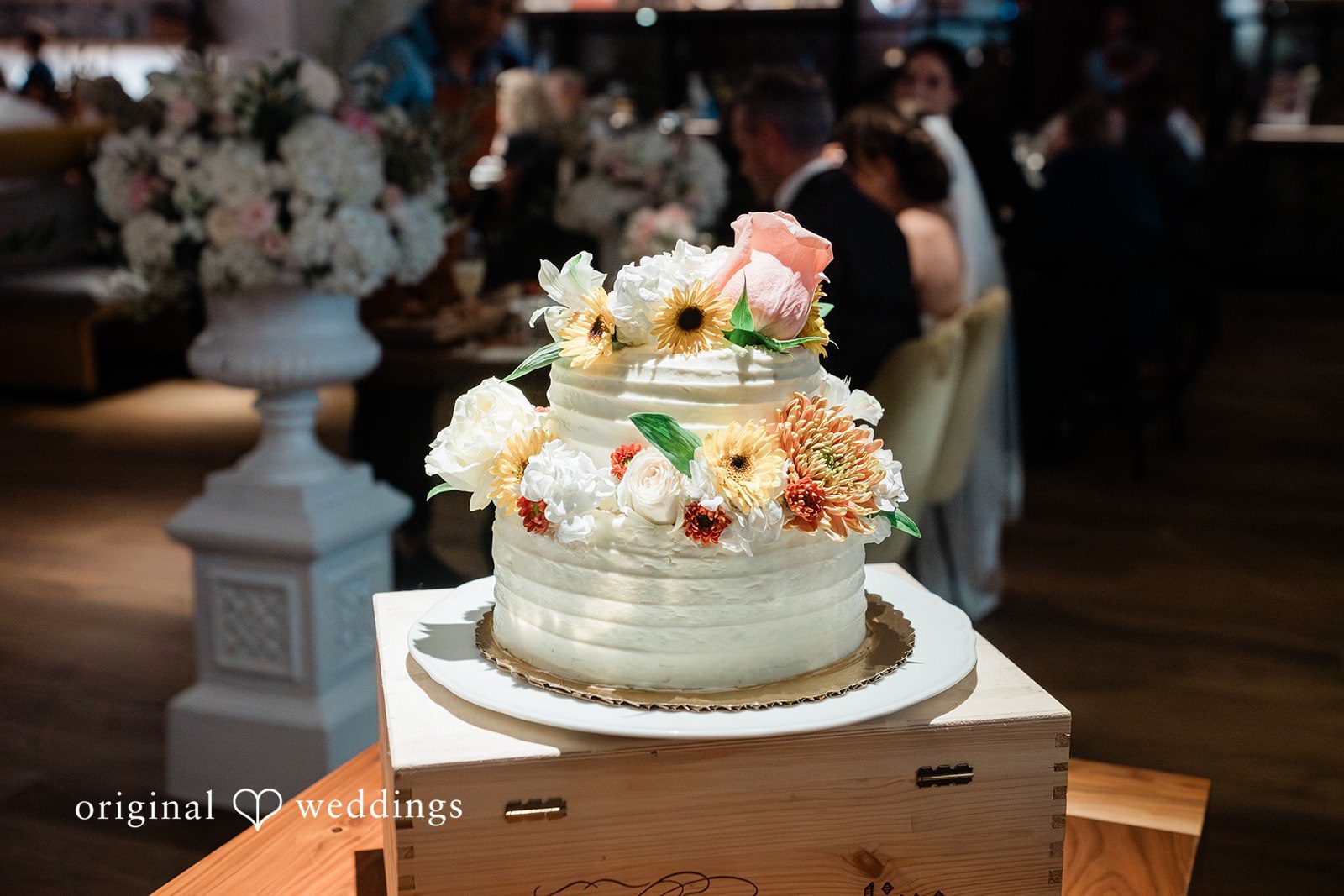 White wedding cake with blush florals at Fleurette