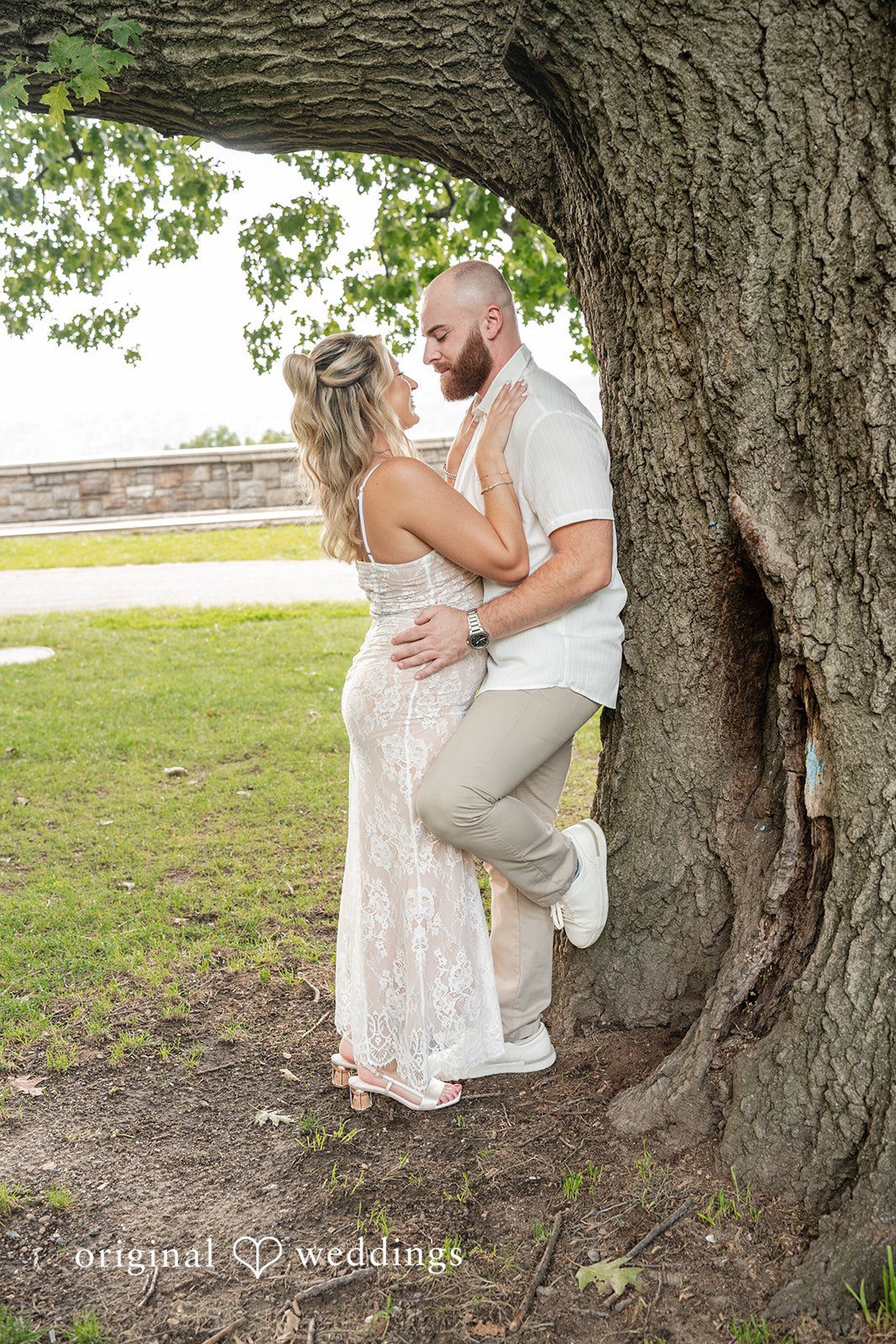 Jackie + Will Our New York City Engagement photographers captured a romantic portrait of the couple by the tree