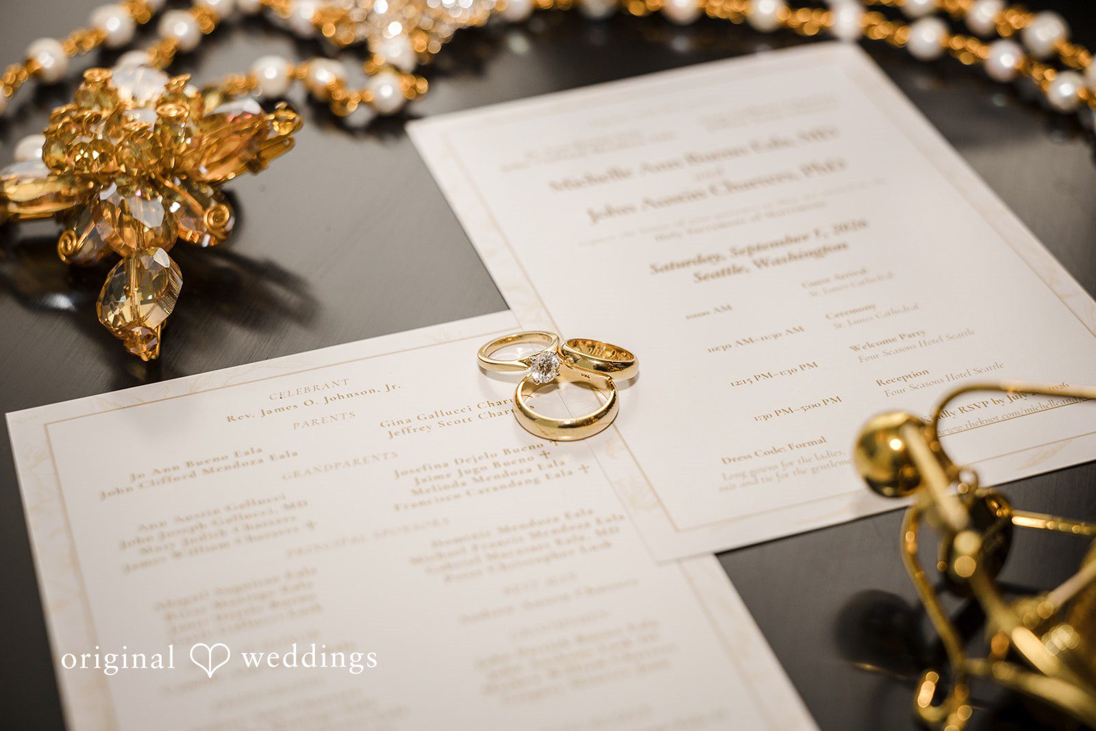John + Michelle Wedding invitation suite styled with a gold ring and accessories.