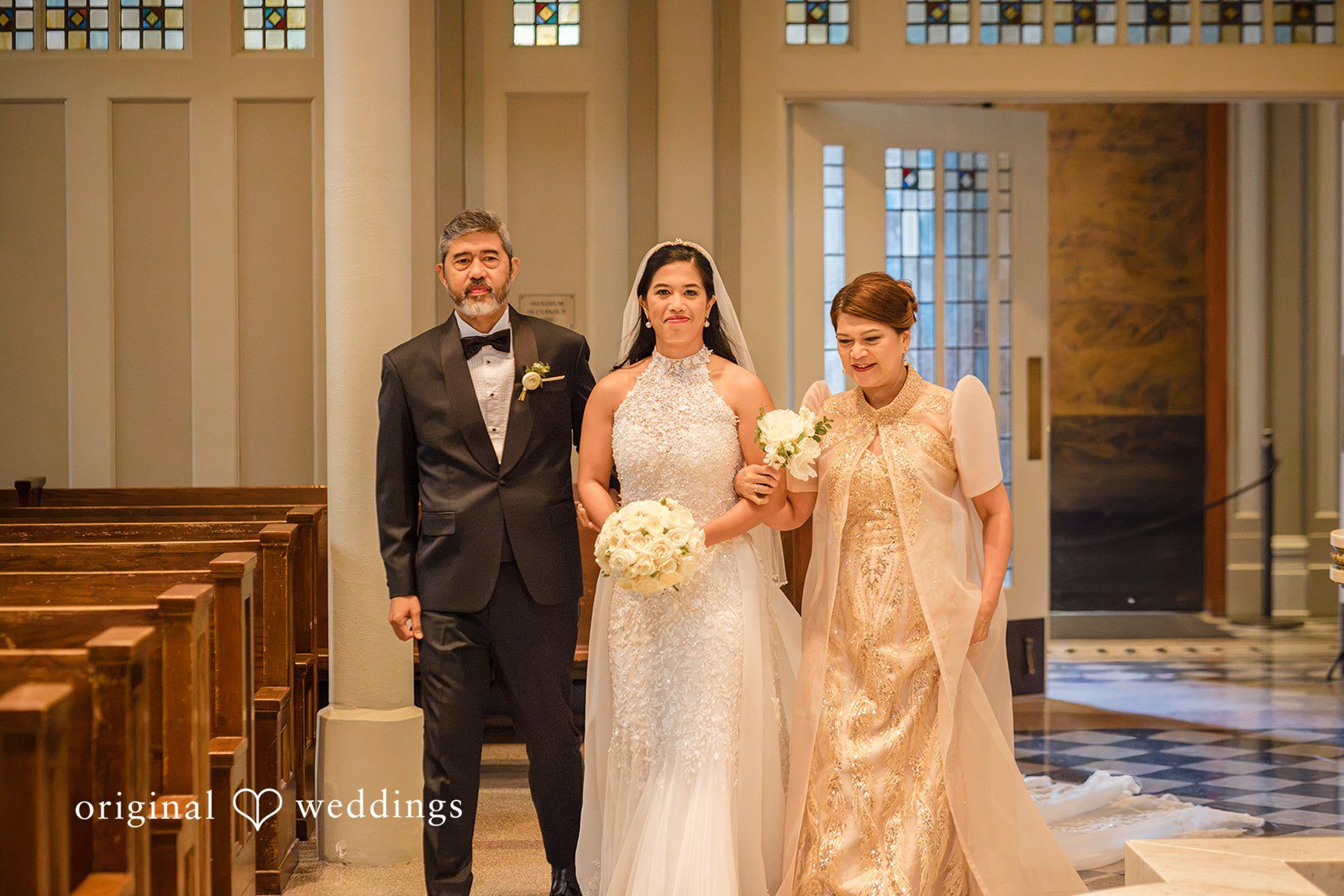 John + Michelle Bride and wedding guest walking down a church aisle.