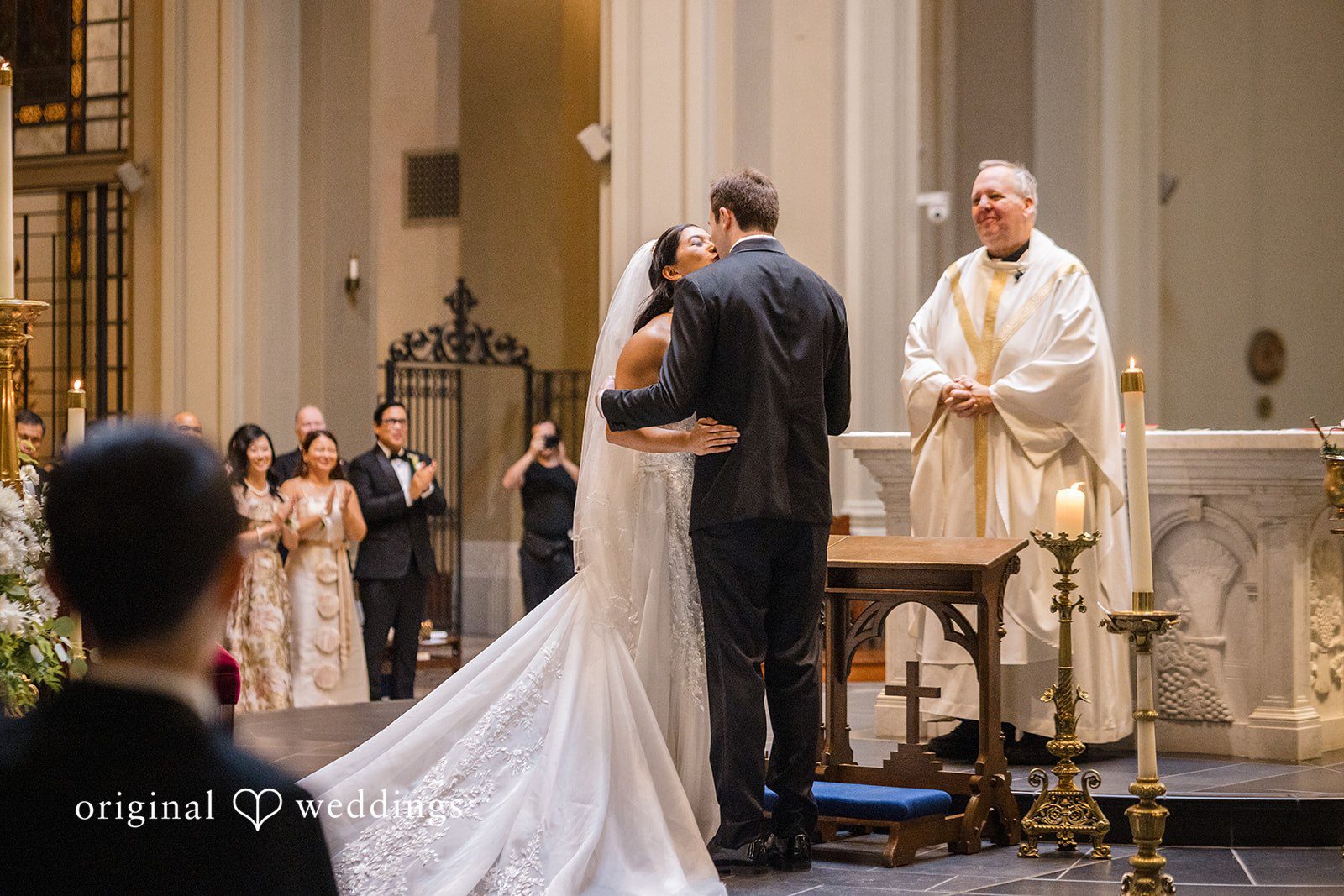 John + Michelle Bride and groom kissing each other after a traditional cathedral wedding.