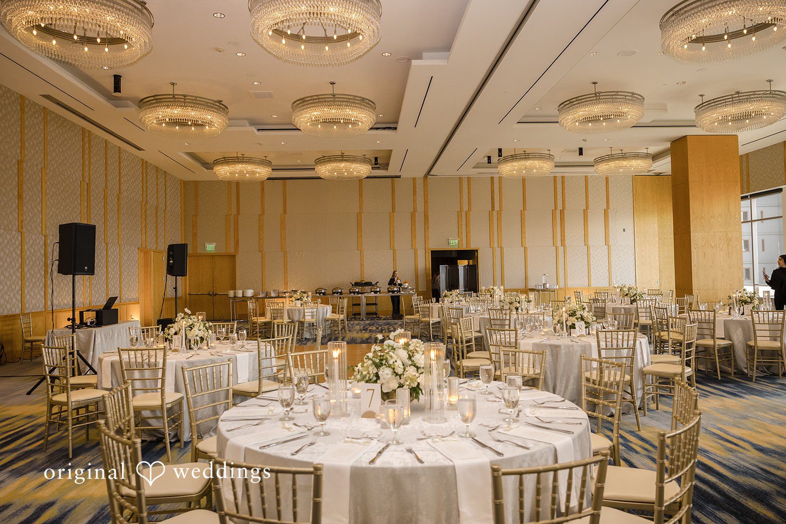John + Michelle Elegant reception hall arranged with round dining tables and chairs.